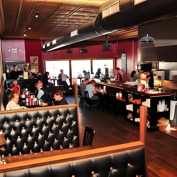 The Anchor Fish & Chips restaurant interior with customers dining at tables and a bar.